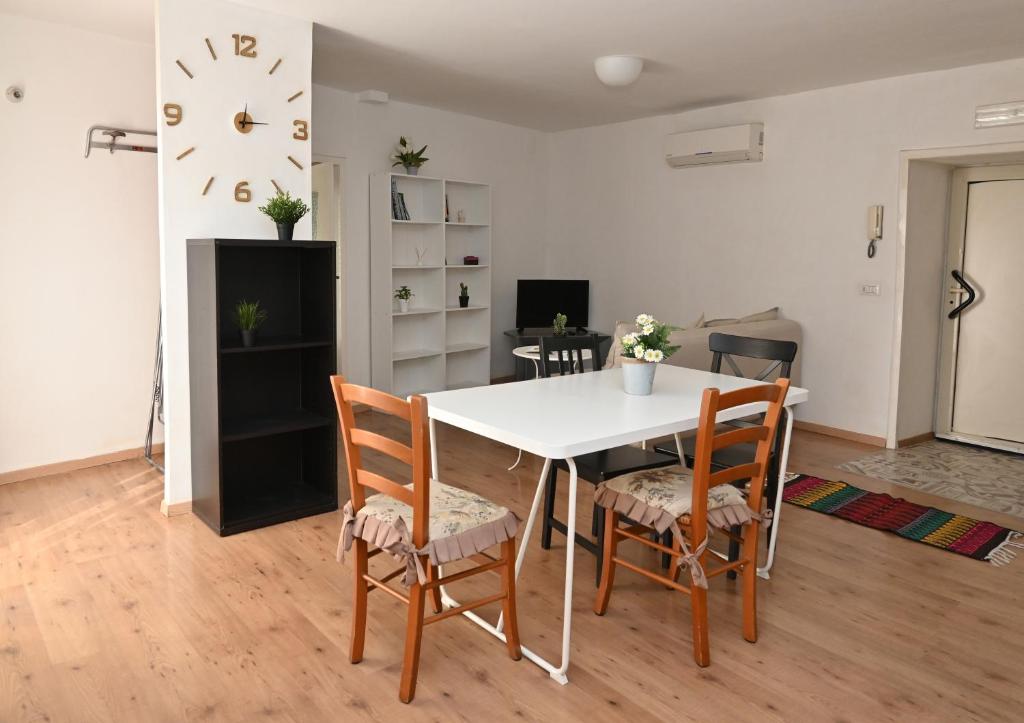 a dining room with a white table and chairs at Sweet Home in Capua
