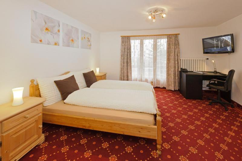 Postel nebo postele na pokoji v ubytování Hotel Alpina