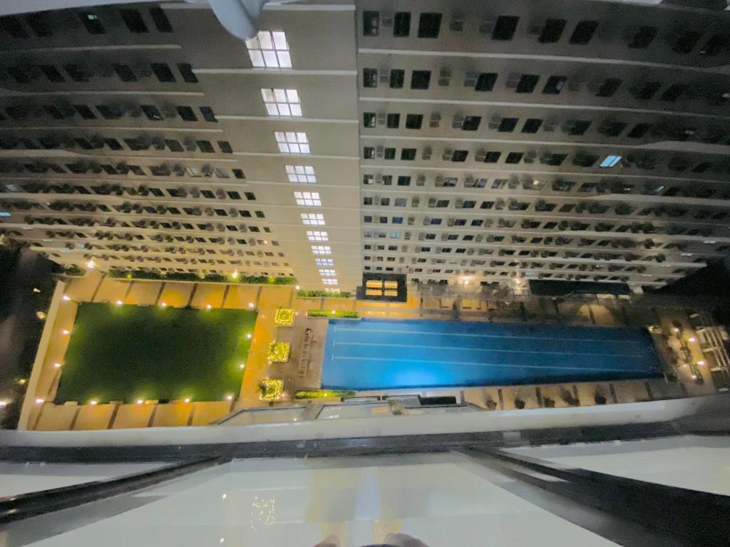 a pool in a large building with two tall buildings at SMDC Green 2 Staycation in Dasma in Dasmariñas
