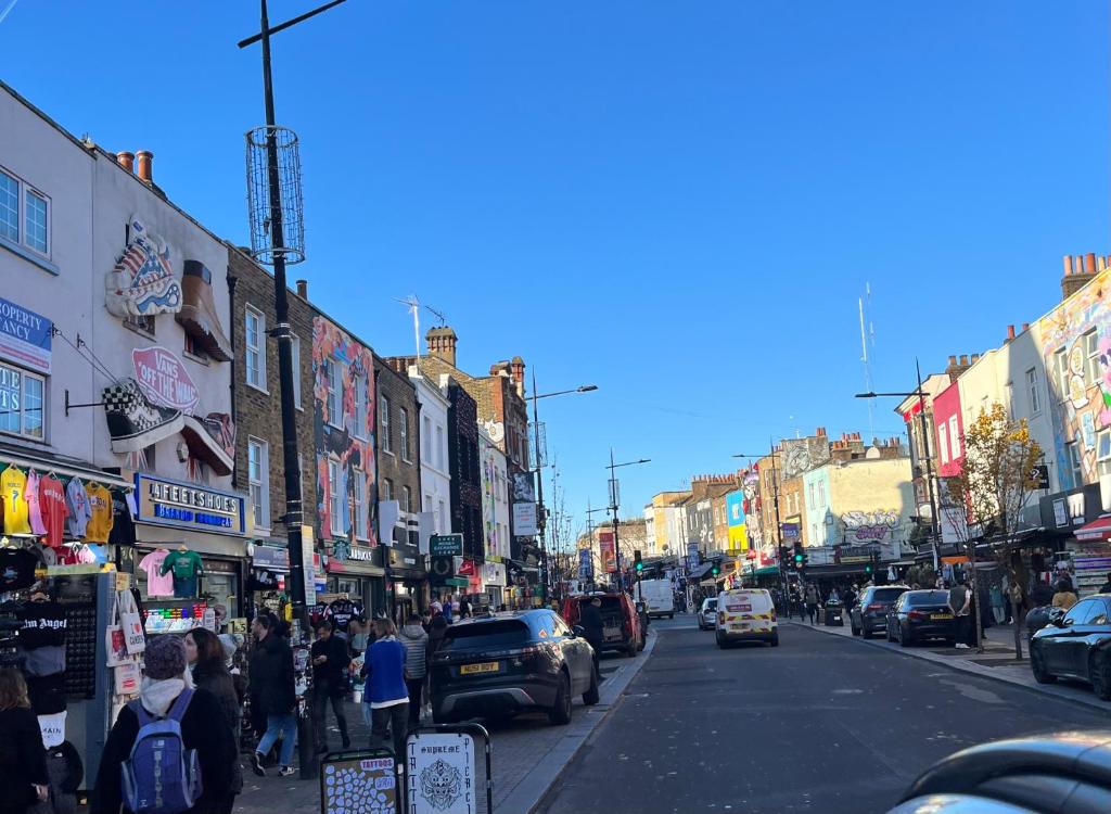 a busy city street with cars and people on the sidewalk at Camden BNB in London