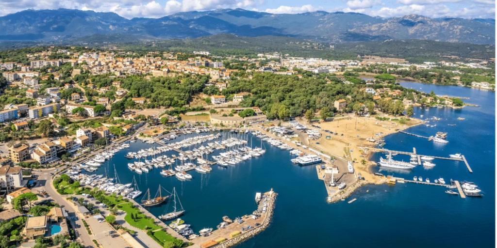 an aerial view of a harbor with boats in the water at Hôtel confidentiel Le Grecale in Pianottoli-Caldarello