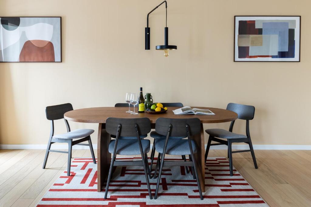 A dining area with a round table and six chairs.