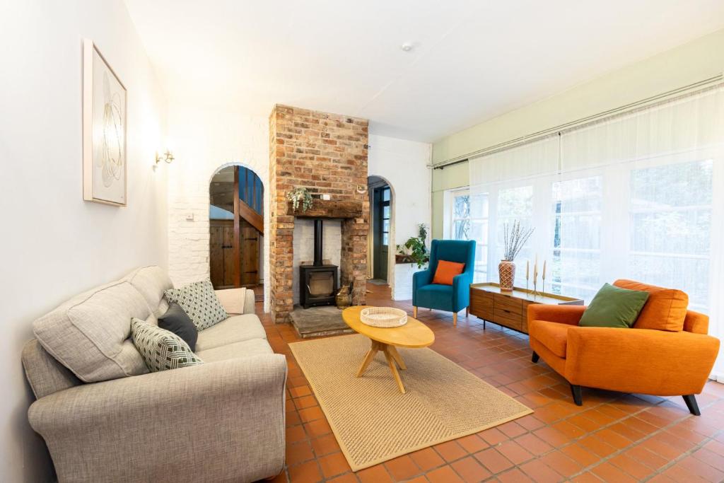 a living room with two couches and a fireplace at GuestReady - Elegant home in Manchester in Manchester