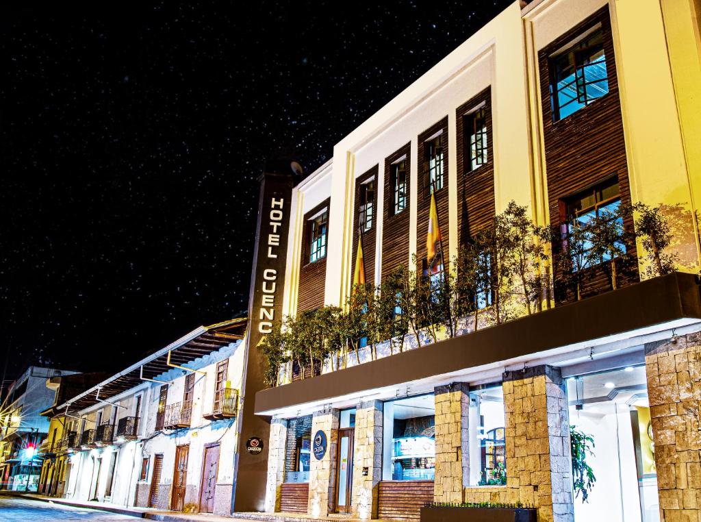 a building on a city street at night at Hotel Cuenca in Cuenca