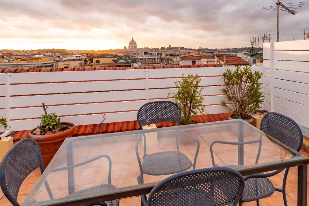 a table and chairs on a balcony with a view at Rooftop 2 BDR Apartment with 360-Degree Views in Rome