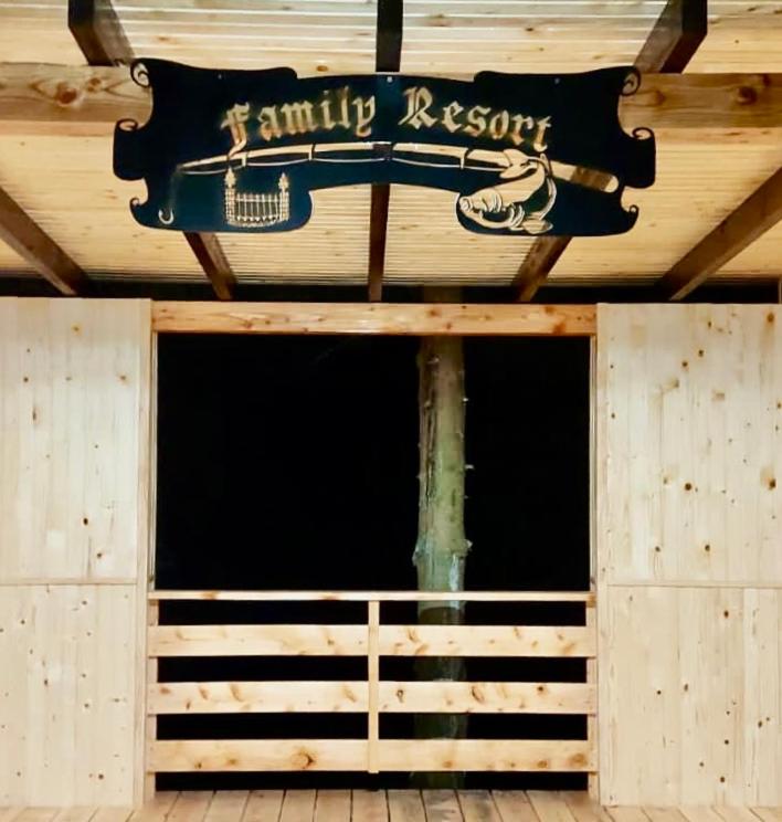 a sign hanging from the ceiling of a building at Family Resort in Mostiska