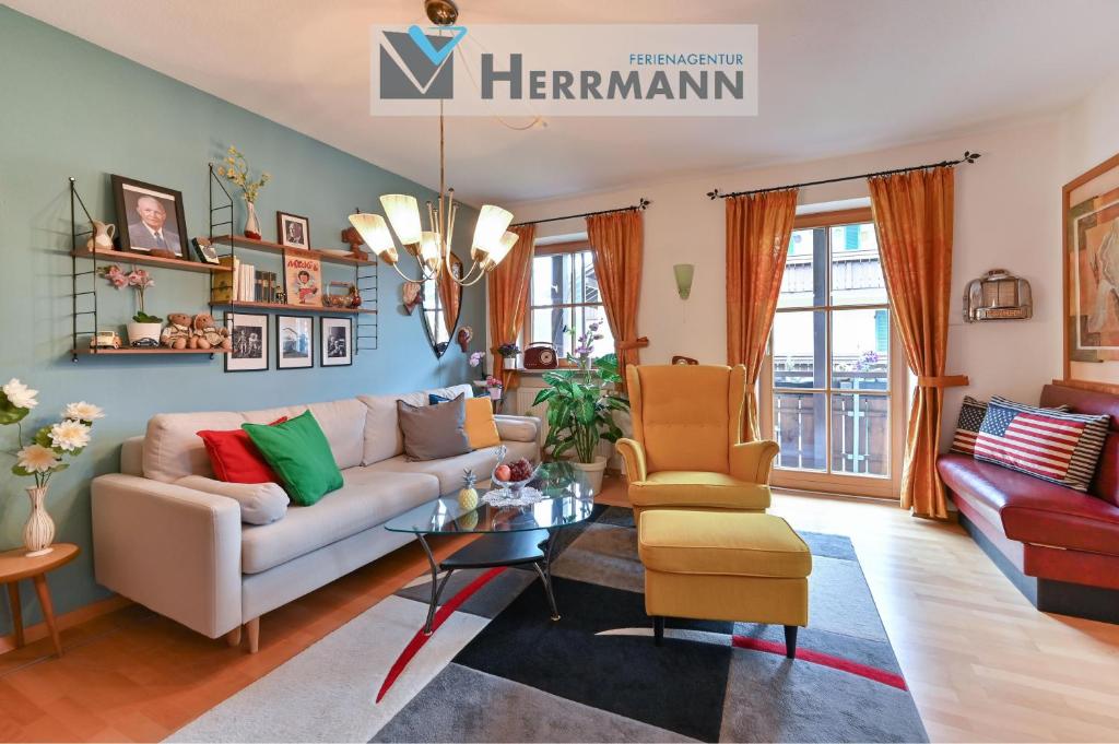 a living room with a couch and a table at Ferienwohnung 50er Vintage Flair in Füssen