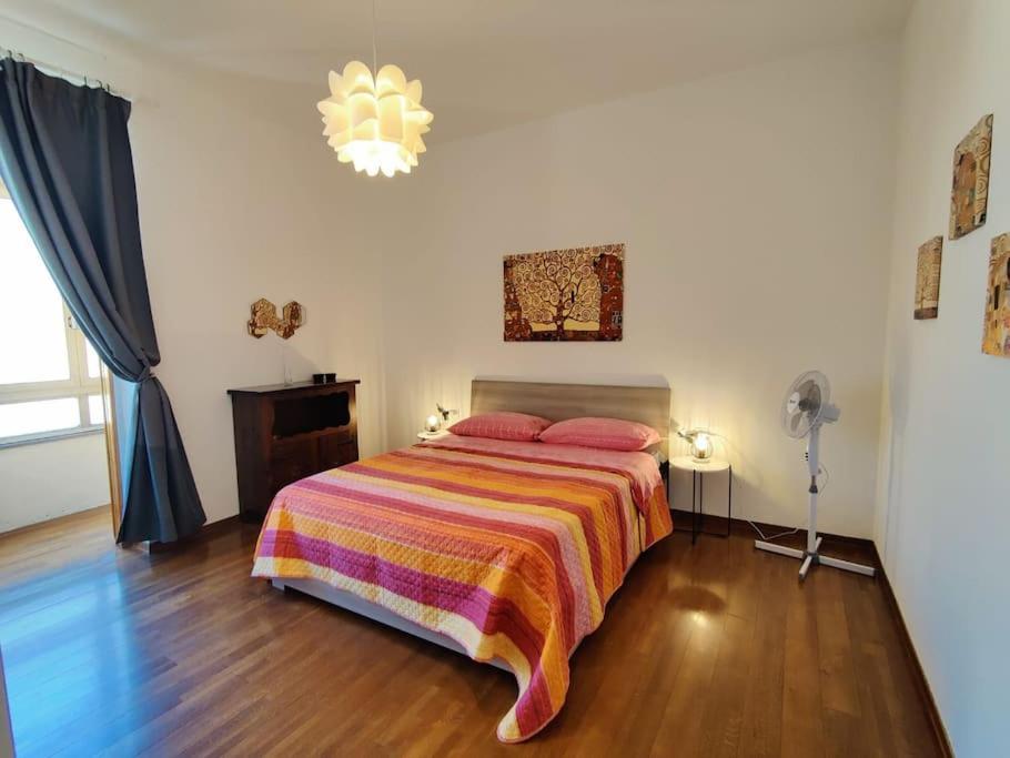 a bedroom with a bed with a colorful blanket at a mio agio apartment in Lecco