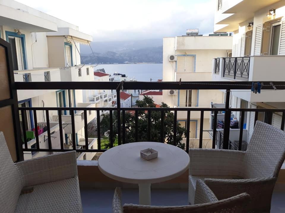 a balcony with a table and chairs and a view of the water at Amaryllis Hotel in Karpathos