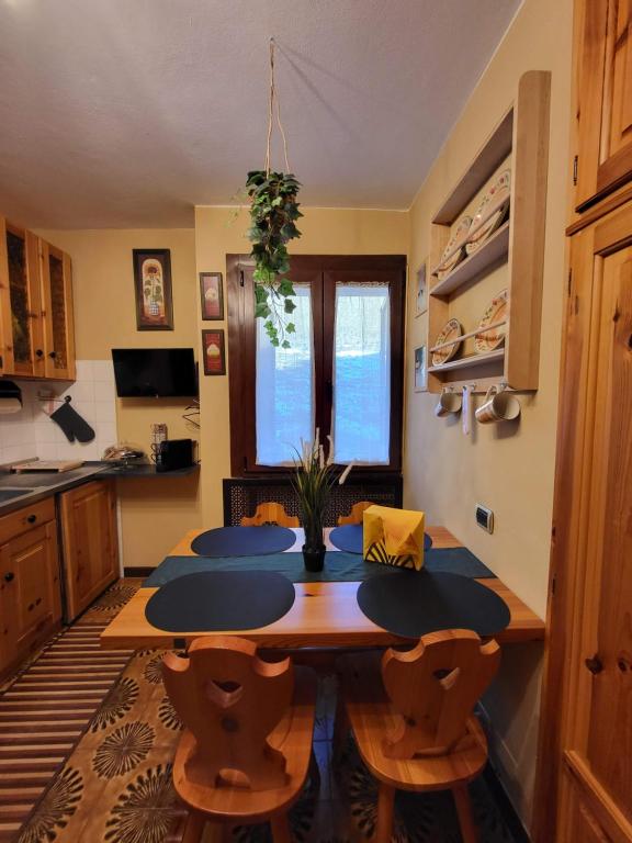 a kitchen with a table and chairs in a room at ViviFoppolo in Foppolo