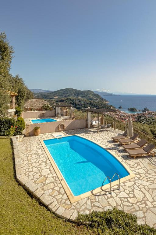 a swimming pool with a view of the ocean at Apolis Villas & Suites Resort in Parga