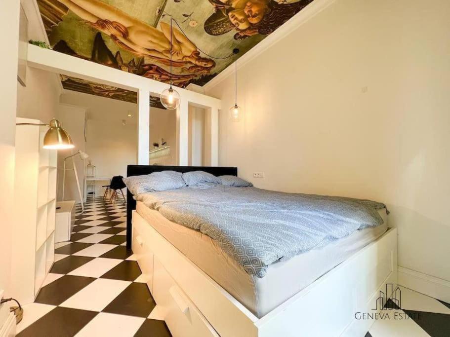a bedroom with a bed on a checkered floor at Aesthetic apartment Krakow-Center in Krakow