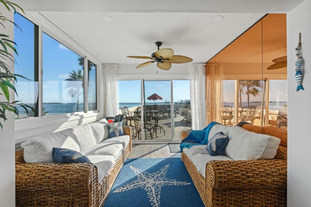 a living room with two couches and a ceiling fan at On the Boardwalk in Long Beach