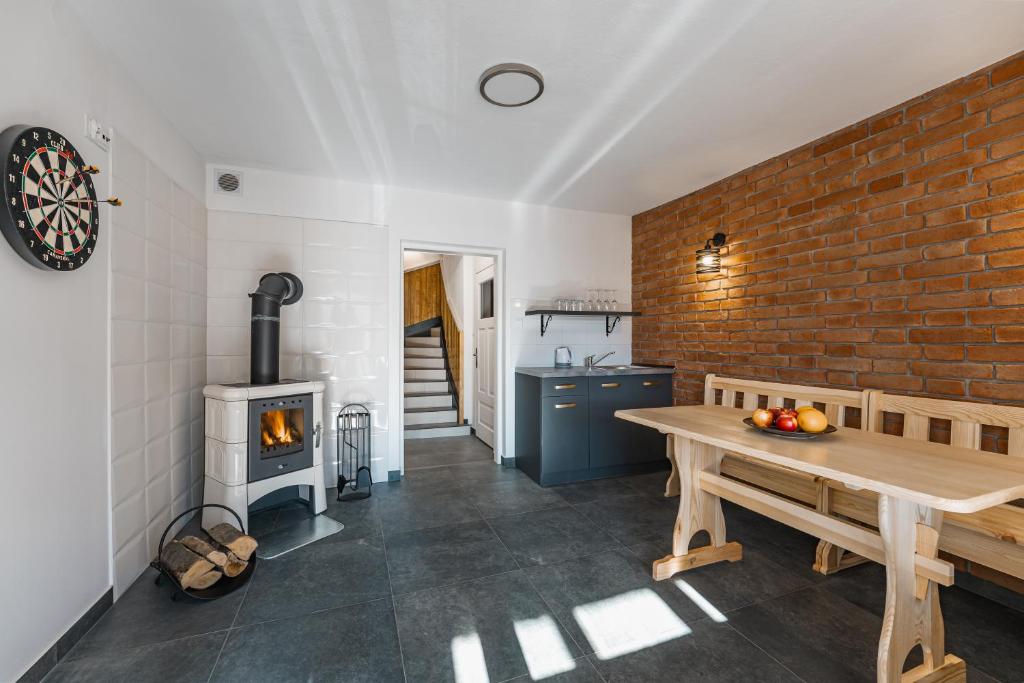 a kitchen with a wooden table and a wood stove at Willa Anna Maria in Szczawnica