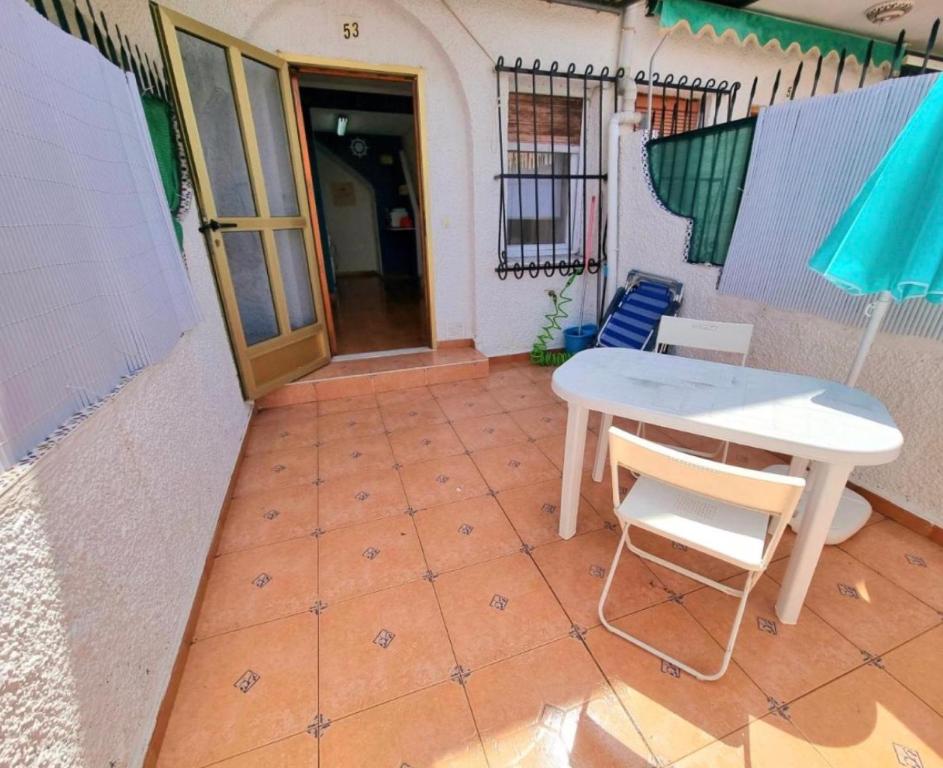 a patio with a table and chairs and an umbrella at Sunflower Playa Lisa in Santa Pola