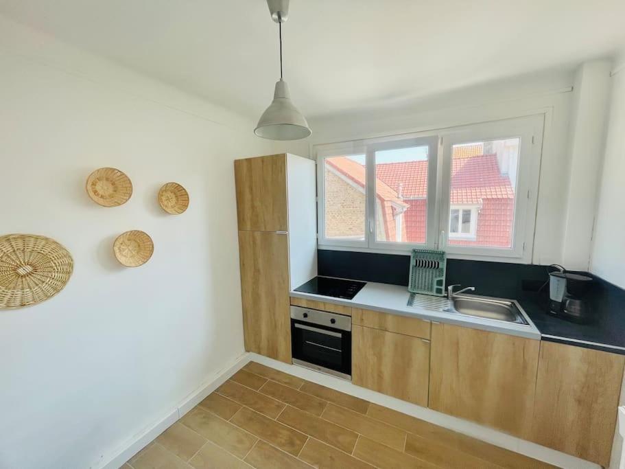 a kitchen with a sink and a window at Calme - Balcon - 2 à 4 pers - WIFI - plage à 100m in Berck-sur-Mer