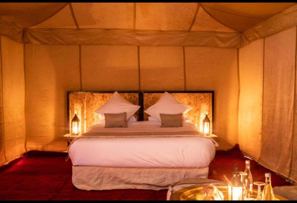 a bedroom with a large bed in a tent at FABIN ATLAS MARRAKECH TOURS in Marrakech
