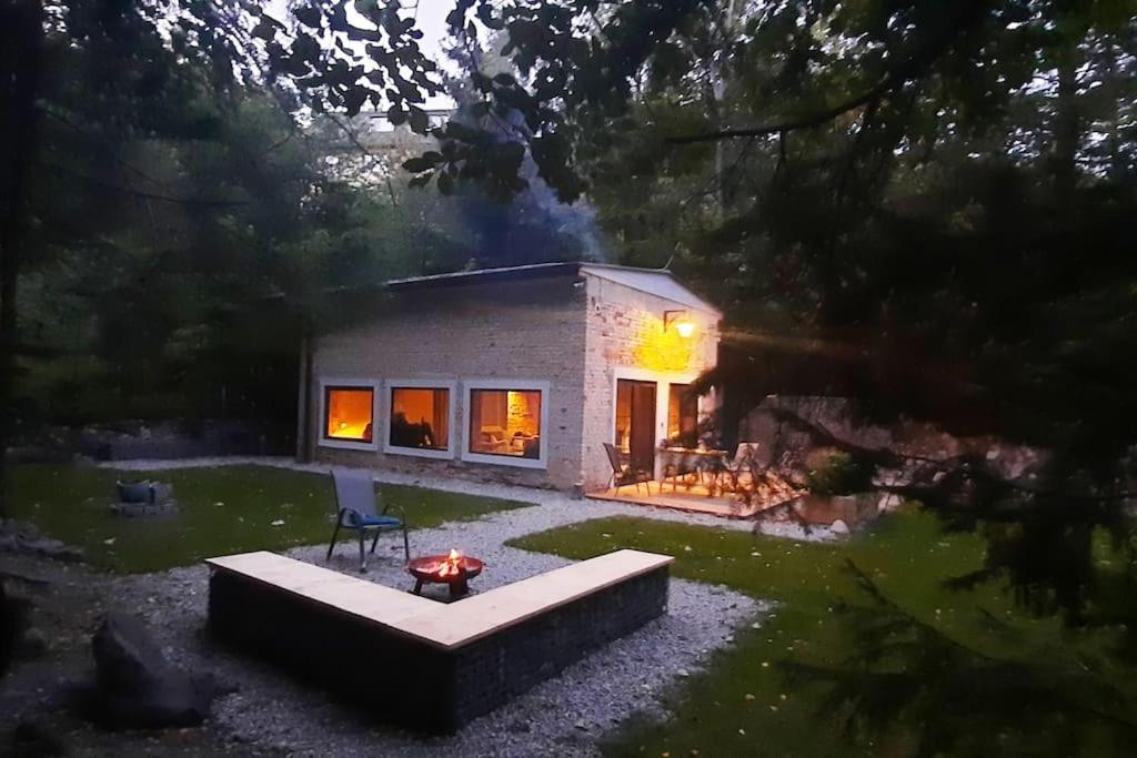 a small house in a yard with a patio at Depo Loco ( Banícke depo) in Špania Dolina