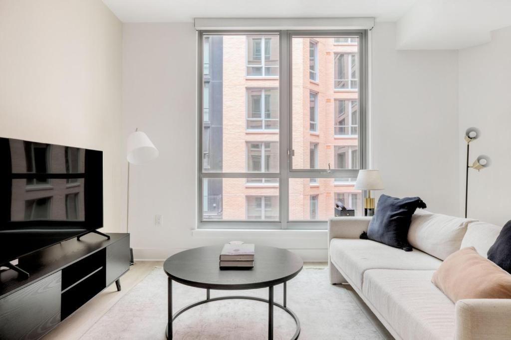 a white living room with a couch and a table at NoMa jr 1br w gym patio wd nr Union Market WDC-687 in Washington