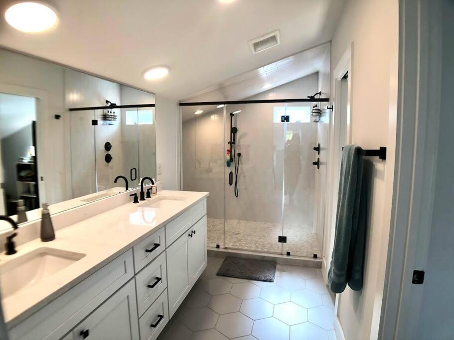 a bathroom with a shower and two sinks and a shower at East Austintacious: walkable airy arty 4 bedroom 3 1/2 bath in Austin