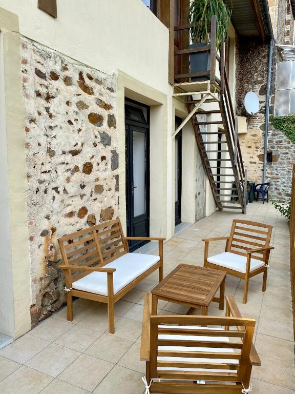 two benches and a table on a patio at Magnifique appartement 2&#47;4 pers - Le Saint Leo in Saint-Léonard-des-Bois