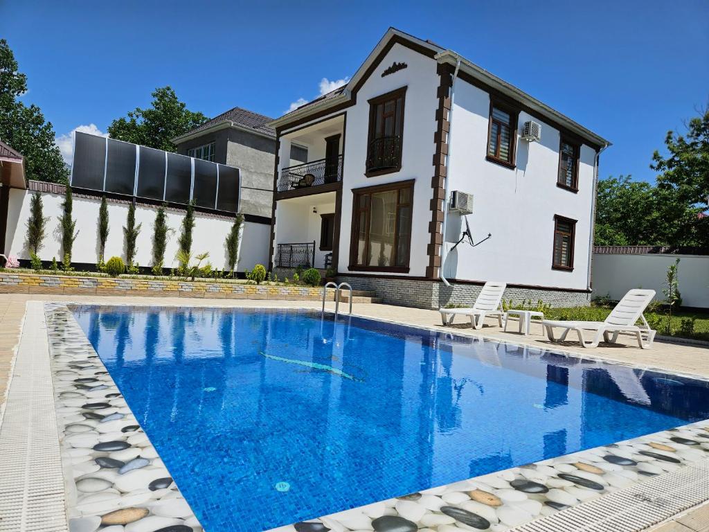 a swimming pool in front of a house at Luxury Milan Gabala hot pool, mountain view, cable car in Gabala