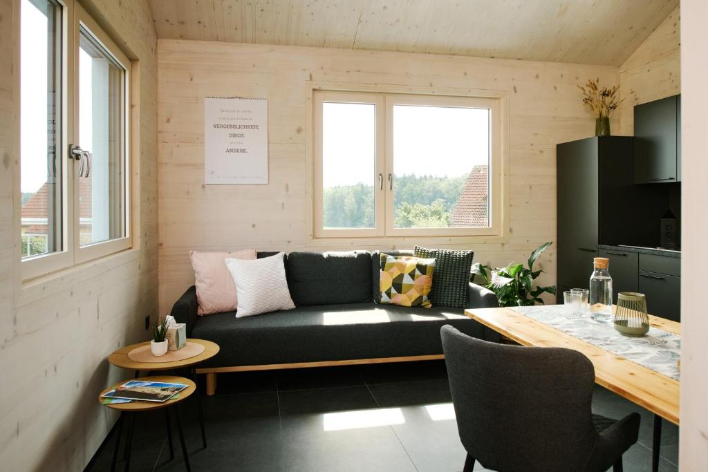 a living room with a couch and a table at Ferienwohnung HolzGenuss in Lehrberg