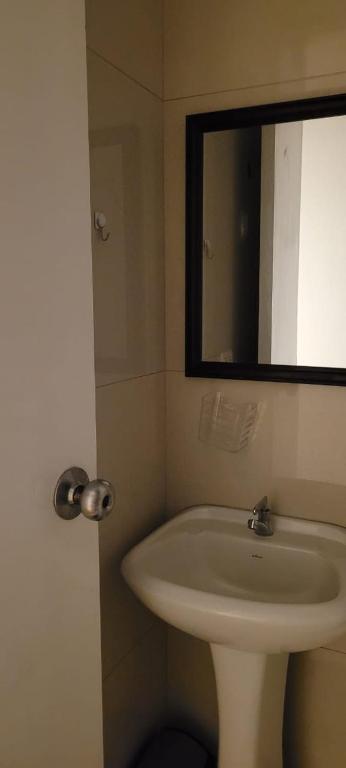 a bathroom with a white sink and a mirror at Alojamiento Orejuelas #204 in Lima