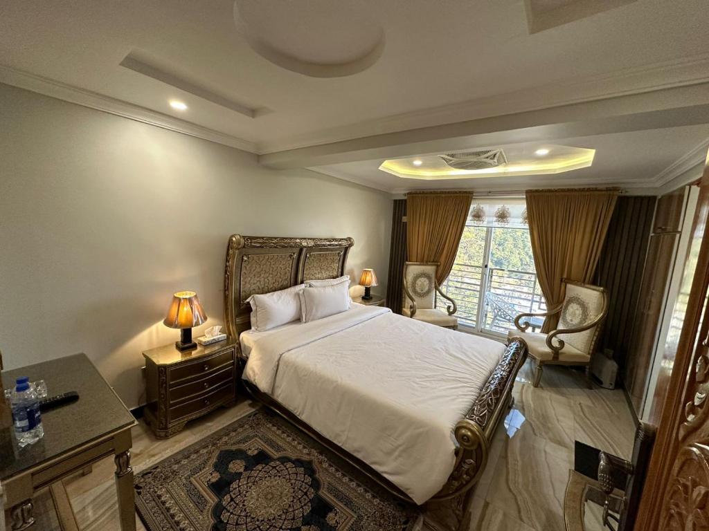 a bedroom with a large bed and a window at Burj A Zafar in Murree