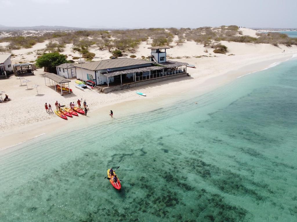 an aerial view of a beach with a boat in the water at Kaia Beach House Boa Vista Front Sea View Apartments in Sal Rei