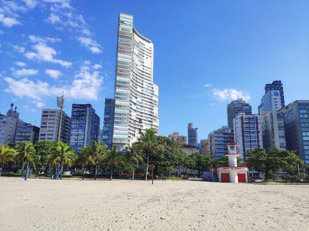a beach in front of a city with tall buildings at Book Santos - Unlimited - Apartamentos Vista Mar em condomínio de Luxo in Santos