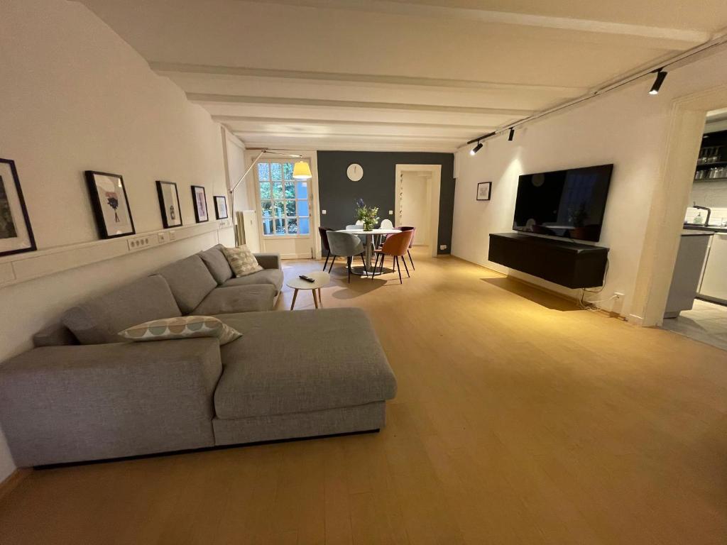 a living room with a couch and a table at The Suites Alster Waterfront Family Apartments in Hamburg