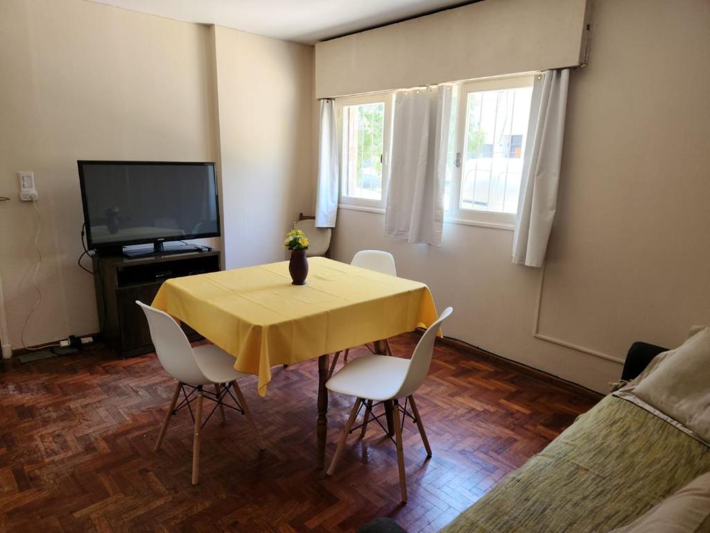 a dining room with a yellow table and chairs at DEPARTAMENTO BARCALA PLENO CENTRO DE MENDOZA in Mendoza