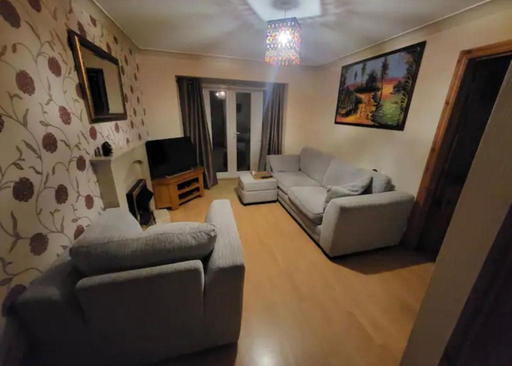 a living room with two couches and a tv at Cosy 2 bed house in the heart of leyland in Leyland