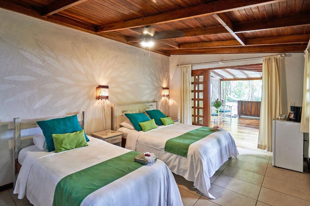 Postel nebo postele na pokoji v ubytování Hotel Tropico Latino