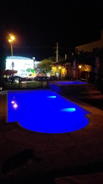a blue light in a parking lot at night at Apart Franchino in Mina Clavero