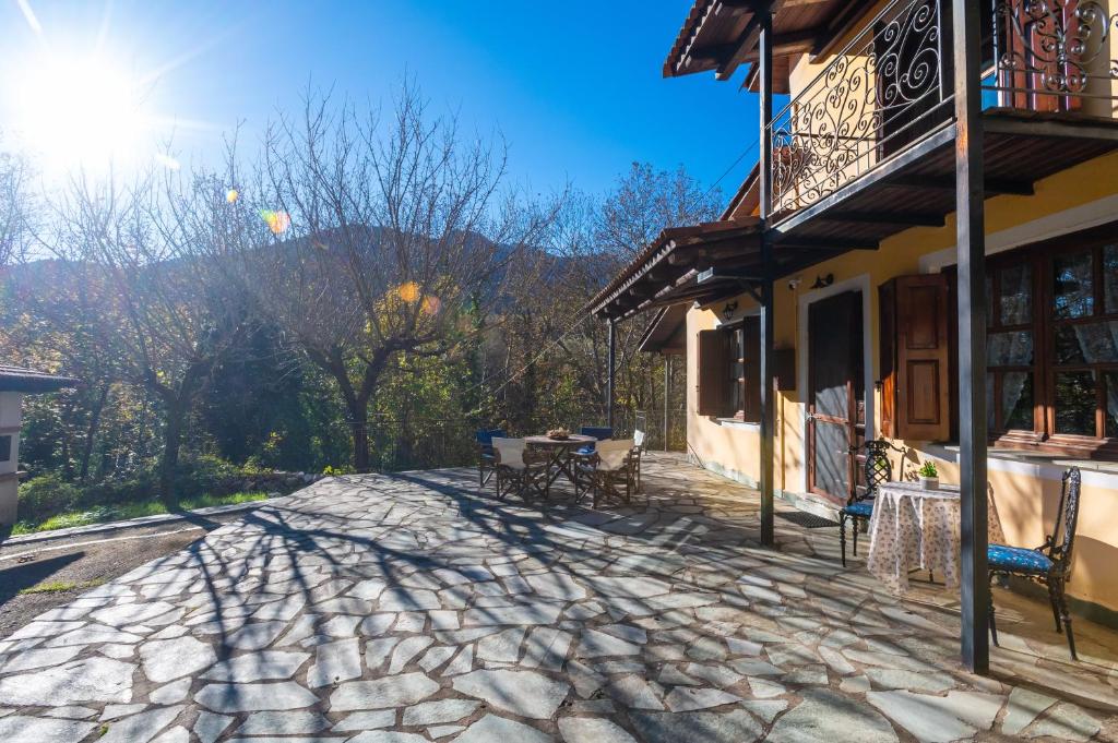 a patio of a building with a table and chairs at RiverHome in Gávros