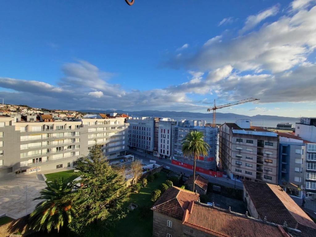 une vue sur une ville avec des bâtiments et des palmiers dans l'établissement APART PL DO PAZO - Sanxenxo, à Sanxenxo