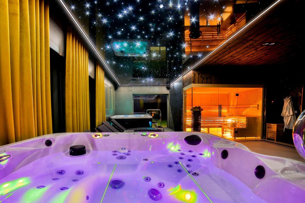 a large purple bath tub in a room at Kompleks Gazdówka Apartamenty - Rabka-Zdrój in Ponice