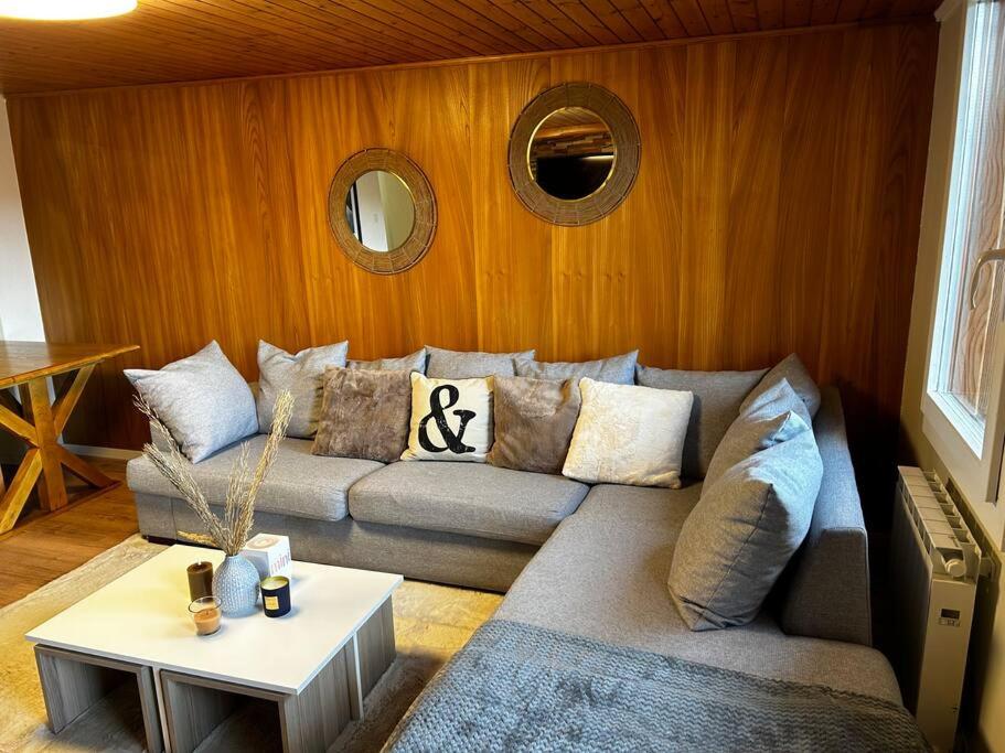 a living room with a couch and a table at SNOW NEST: Superbe cocon enneigé in Crans-Montana