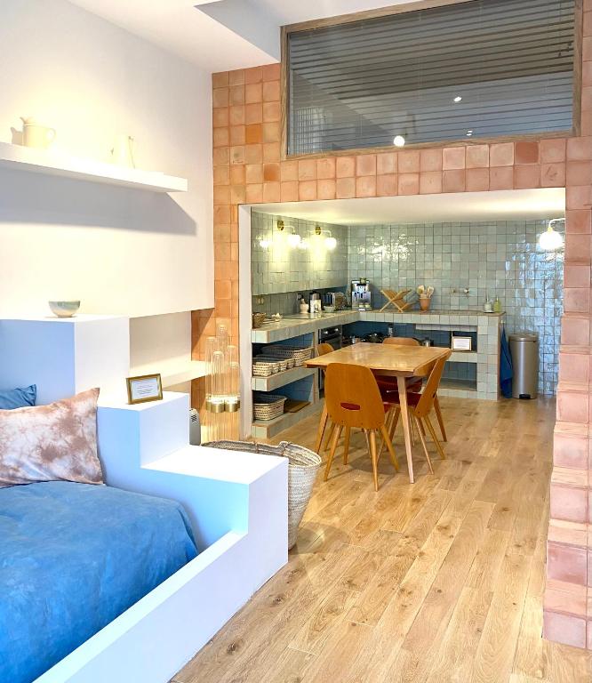 a bedroom with a bed and a dining room at L&#39;Annexe de la Madrague Marseille in Marseille