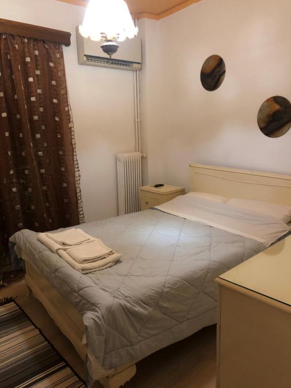 a small bedroom with a bed with towels on it at Small flat with everything near metro in Piraeus