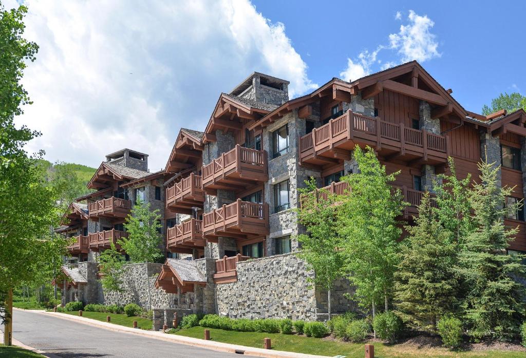 a large apartment building with balconies on a street at Hummingbird C102 Condo in Beaver Creek