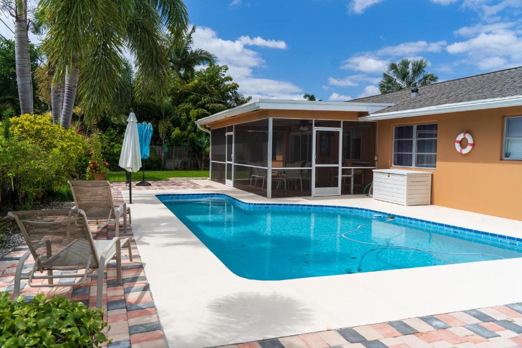 a swimming pool in front of a house at Mt Irvine Luxe Pool Cottage/Close to Beach and Equestrian in Florida Gardens