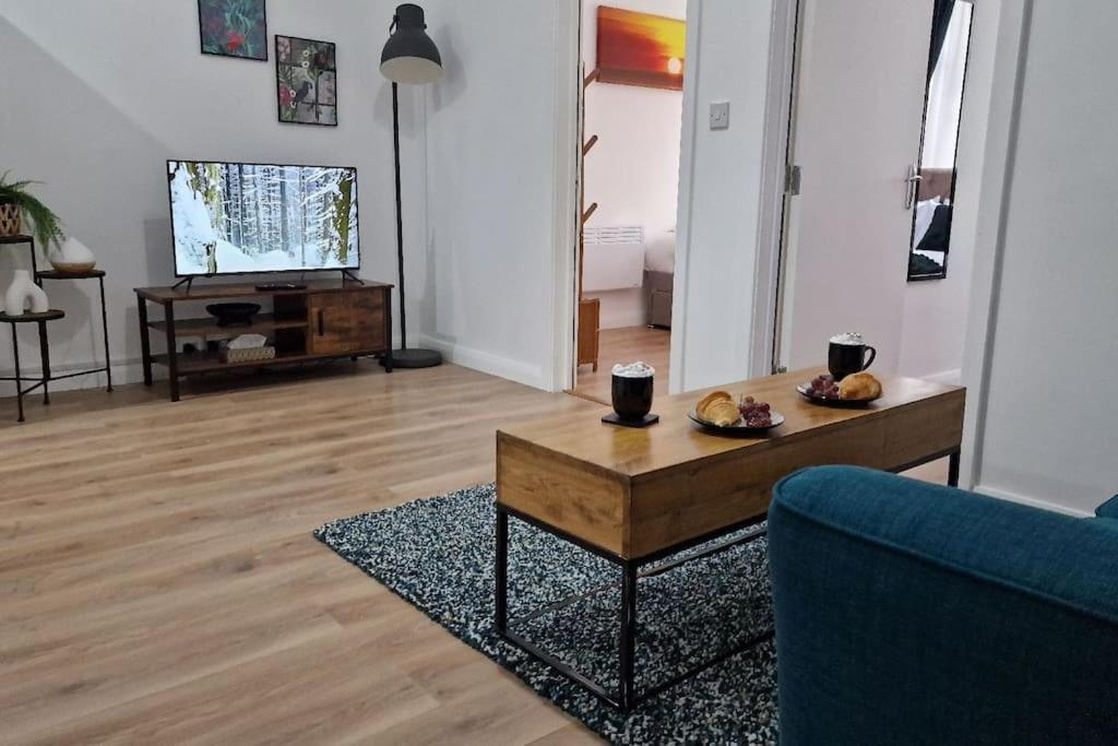 a living room with a couch and a coffee table at Cosy 2 Bedroom Apartment in Birmingham