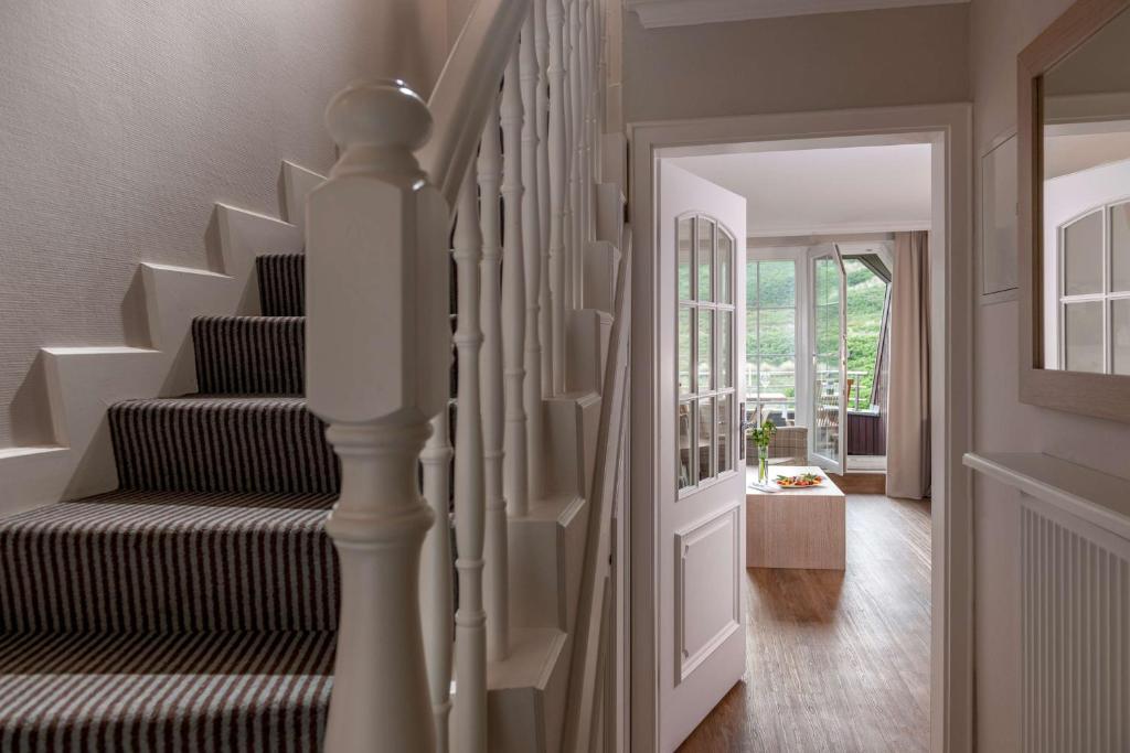 a staircase in a home with a stair case at Dorint Strandresort & Spa Westerland/Sylt in Westerland