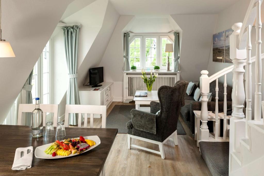 a living room with a plate of fruit on a table at Dorint Strandresort & Spa Westerland/Sylt in Westerland