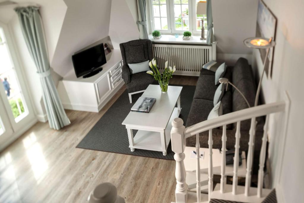 a living room with a couch and a table at Dorint Strandresort & Spa Westerland/Sylt in Westerland