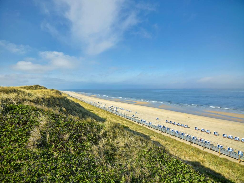 an aerial view of a beach and the ocean at Dorint Strandresort & Spa Westerland/Sylt in Westerland
