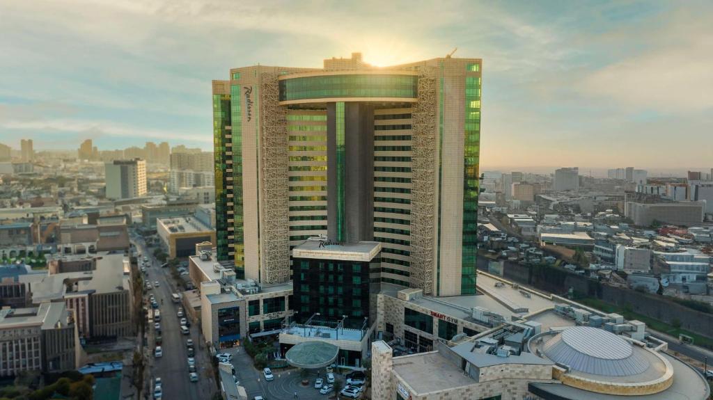 a view of a city with a tall building at Radisson Hotel & Residences Erbil in Erbil